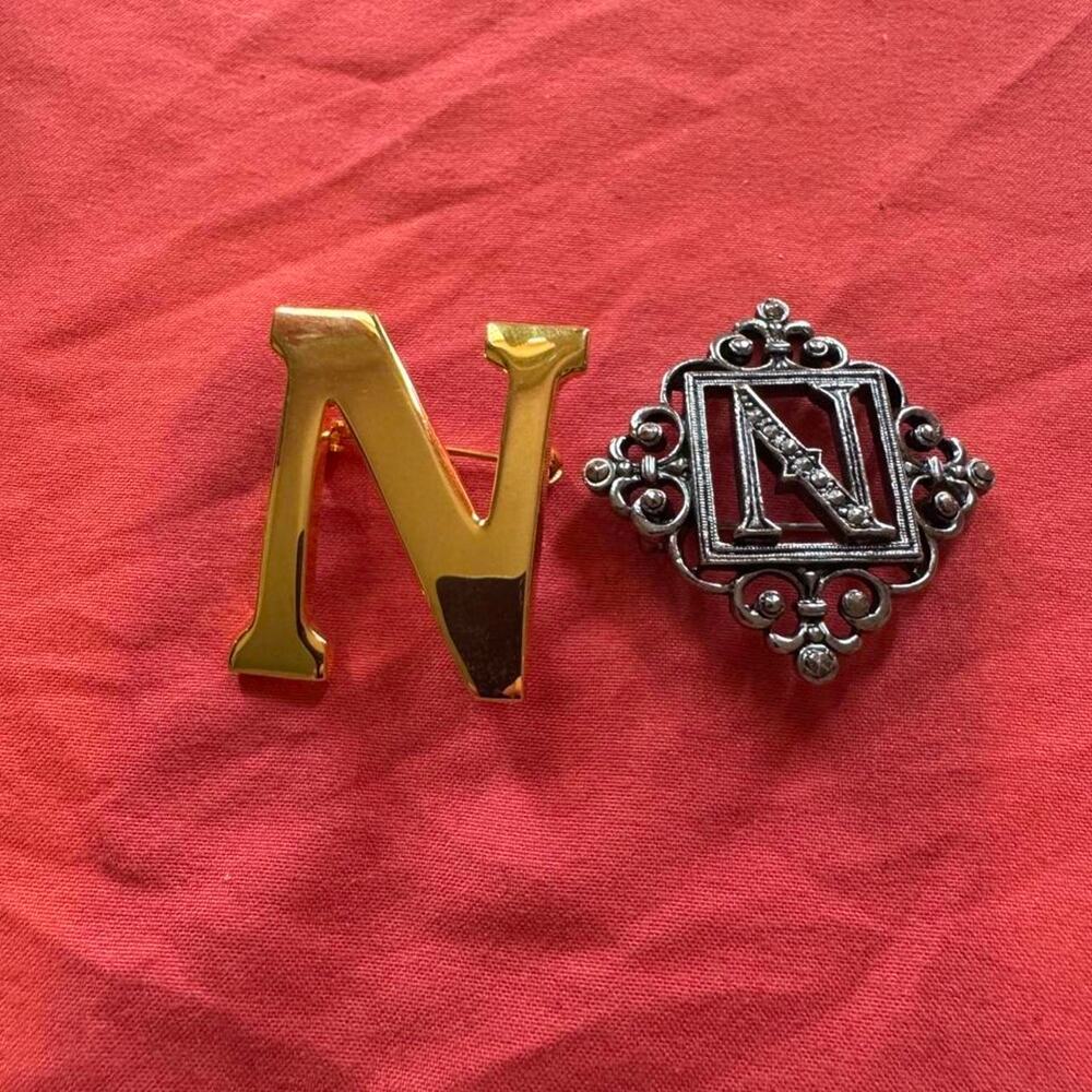 Gold and silver toned letter N brooches